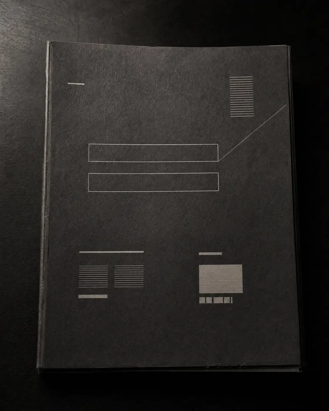An abstract dark document cover with redacted visual elements