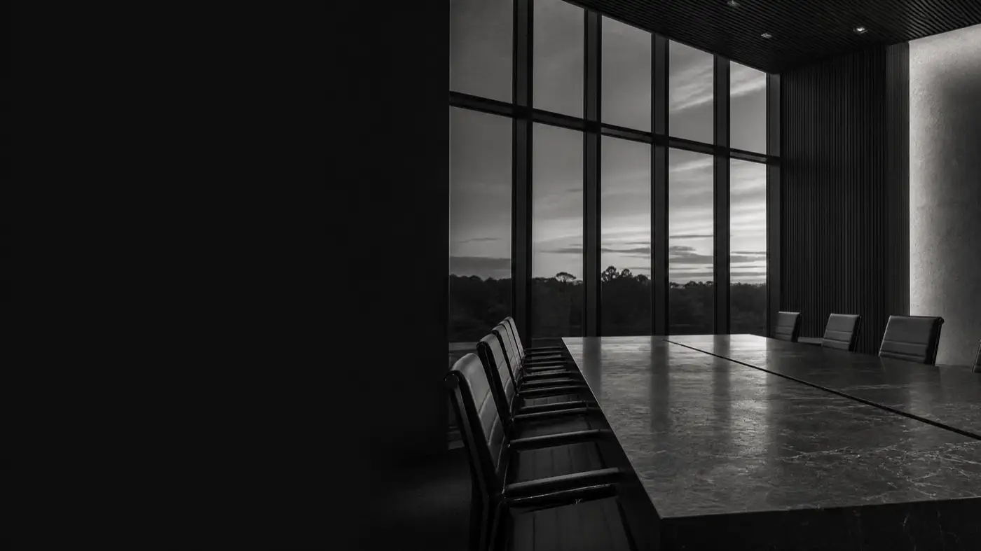 A dark, monochrome institutional office interior